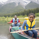 “Father and daughter canoeing in lake.”